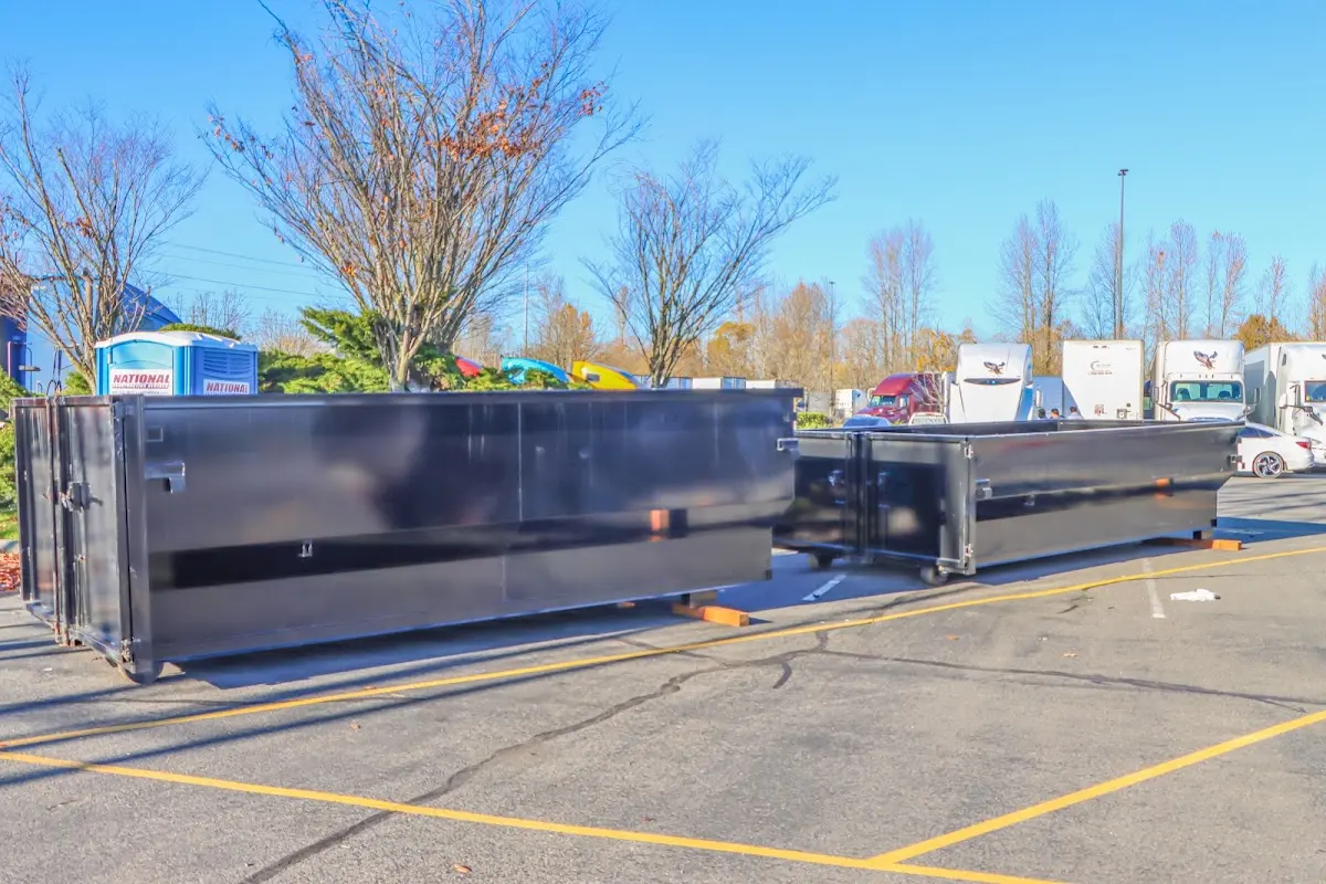 Professional dumpster rental service with roll-off container on residential driveway in Canfield